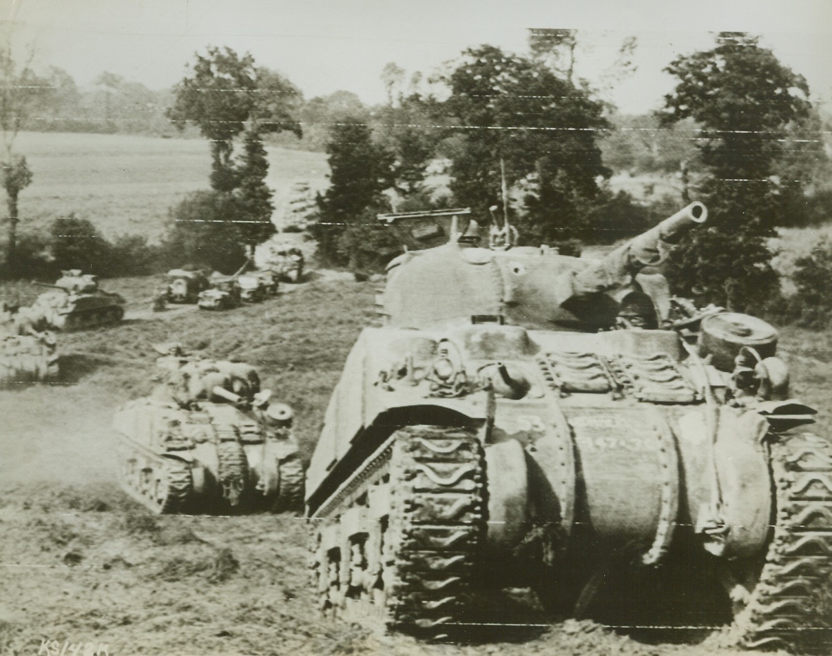 BRITISH TANKS MOVE UP TO FRONT, 8/2/1944.CAUMONT, FRANCE—A column of British-manned Sherman tanks move forward through a wooded area south of Caumont to take part in the heavy British offensive against the Germans in this section. Credit (British Official Photo via US Army Radiotelephoto from ACME);