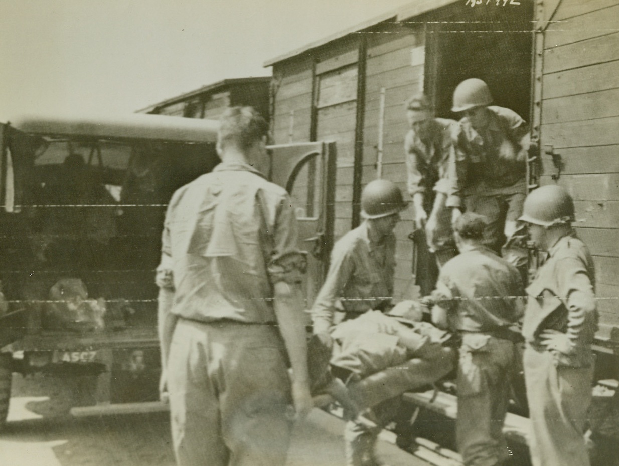 Load First Hospital Train, 8/8/1944. France – Wounded men are loaded aboard the first Allied hospital train to operate in France since D-Day, on a siding at Lison. They will be taken to Cherbourg on their way to England. Credit: Army photo from ACME;