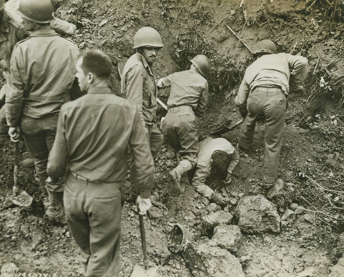 Medics to the Rescue, 8/7/1944. Somewhere in France – Working feverishly with their shovels, medical men attached to an infantry unit serving in France dig out some of their men who were buried beneath an avalanche of dirt when enemy shells struck. Credit: US Army photo from ACME;
