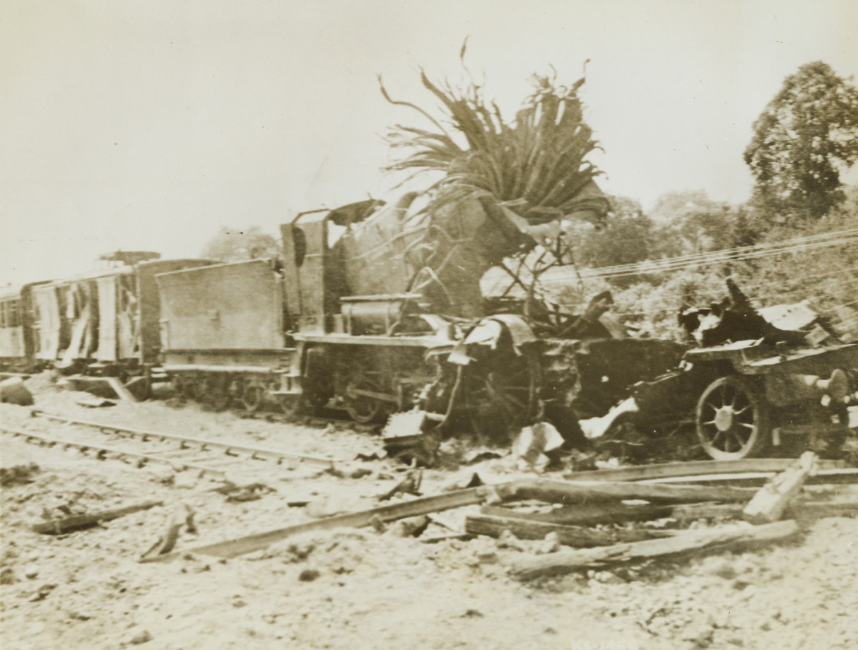 Shattered Nazi Rail Linem, 8/5/1944.France – Twisted steel is all that remains of this Nazi locomotive after an American dive bomber let loose its load of destruction. Continual hammering at Nazi rails has considerably hampered their movement of supplies and troops. Credit: Army photo from ACME;