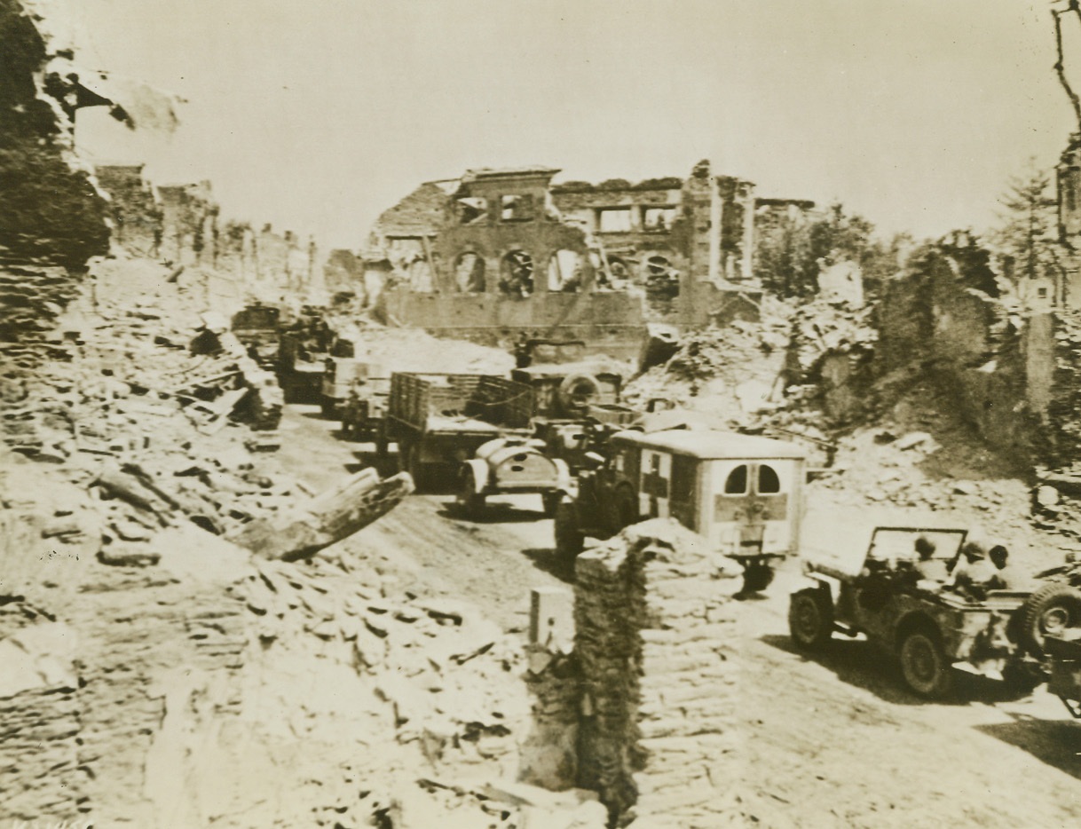 St. Lo Now at Yank Rear, 8/5/1944. France – Military traffic streams through devastated St. Lo, just a little while back the scene of terrific battles, but now far behind the fighting front. Yank advance through Brittany is at a speed almost greater than that achieved by any army in World War II. Credit: Army photo from ACME;