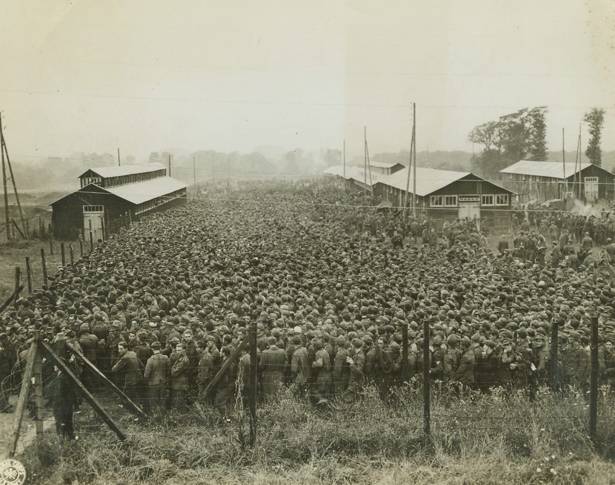 Ten Thousand Hungry “Supermen”, 8/29/1944. France – In this compact mass, stretching far into the background, are ten thousand German prisoners, captured during the Allied drive in France. It’s “chow time” here, and they’re lining up for their lunch in their stockade somewhere in France. Credit: Signal Corps Photo from ACME;