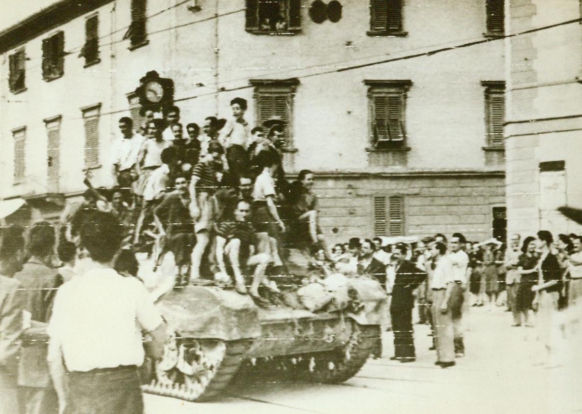 Joyous Welcome For British 8th Army, 8/14/1944. Florence, Italy—Joyous civilians jump on top this South African-manned tank as it enters Florence, while others cram the streets to watch the coming of the victors. After the British 8th Army had overcome all Nazi Resistance, AMU officials rushed in to give aid to the needy citizens. 8/14/44  Acme RadioPhoto;