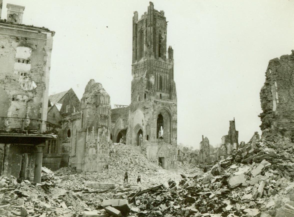 The Path Of War's Destruction, 8/2/1944. St. Lo, France – A French soldier and a GI stand among the ruins of St. Lo and gaze mutely at the Notre Dame Cathedral, which has been shattered throughout by the force of the battle in this key town. 8/2/44 (ACME);