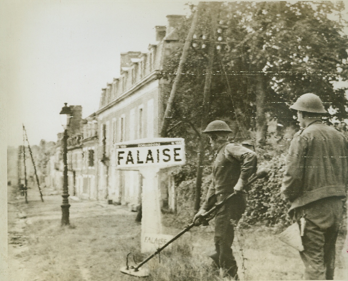 Mine Sweepers, 8/18/1944. FALAISE, FRANCE -- Canadian sappers search for mines along the grass borders lining the streets of Falaise as they enter the town taken in the drive toward Paris. Credit (Signal Corps Radiotelephoto from ACME);