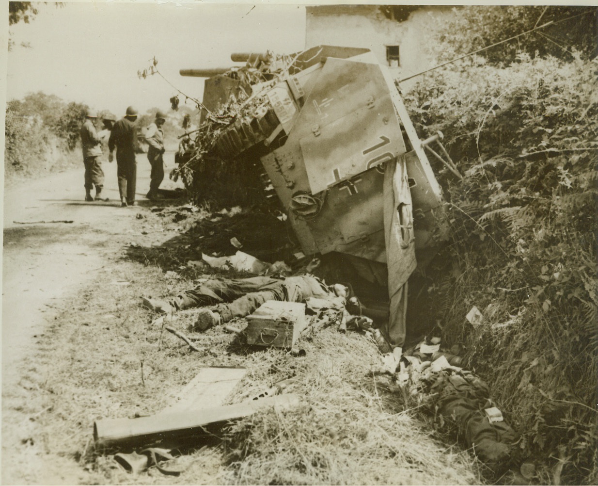 Where Nazi Panzers Were Trapped, 8/3/1944. France—Wrecked German armored vehicles and their dead crew members lie along this road in Roncey, where they were trapped by American troops and destroyed by supporting Allied fighters and rocket bombers. The U.S. Second Armored Division sprung the trap on the Nazis. Credit: ACME;