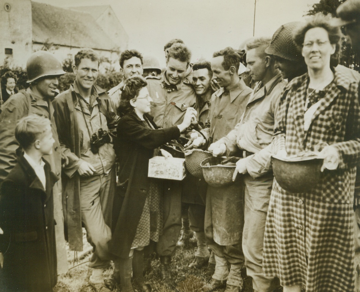Yanks in Belgium Get Eggs – Whole, 9/6/1944. BELGIUM – Happy villagers of Forge Philippe in Belgium shower American forces with gifts of eggs, chocolate and flowers after their swift advance had carried them across the Belgian border from France. Nazis retreat with ever-increasing speed before our relentlessly advancing forces.Credit – WP – (Acme);