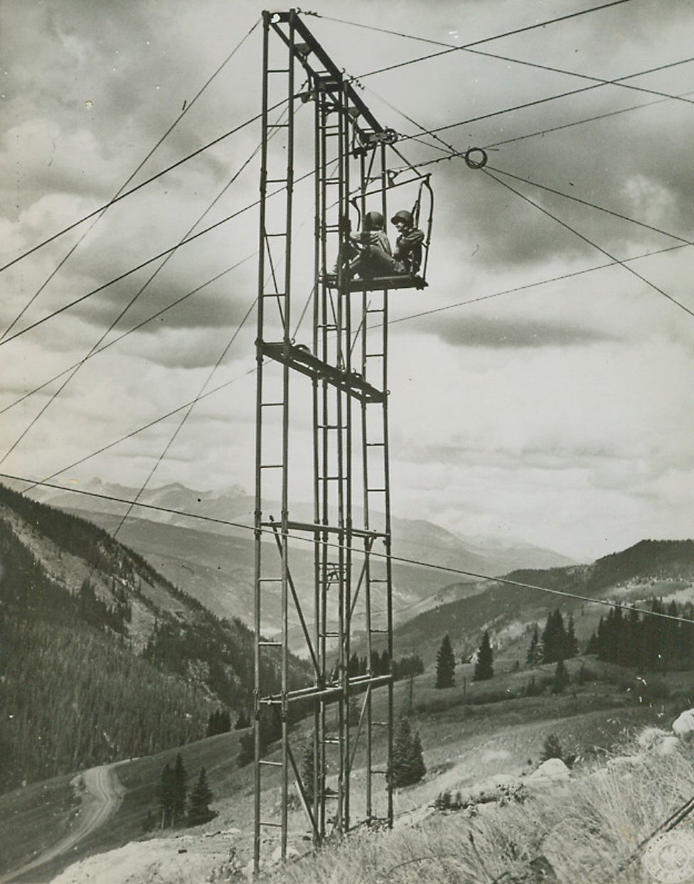 Light Aerial Tramway M-2, 9/21/1944. CAMP HALE, COLO. - The transportation of ammunition, food, and water, the evacuation of wounded personnel, and the moving forward of artillery for mountain troops in terrain too rough for pack animals or men has long been a serious problem for mountain fighters. The Army recently offered to the public its solution of this problem here when the Camp Hale Test Branch of the Mountain and Winter Warfare section of the Army's Engineer Board gave a demonstration of the recently perfected Light Aerial Tramway M-2. A closeup view of the twin tower construction, showing a car passing through. The towers are so built as to be quickly disassembled and moved to a new location.;