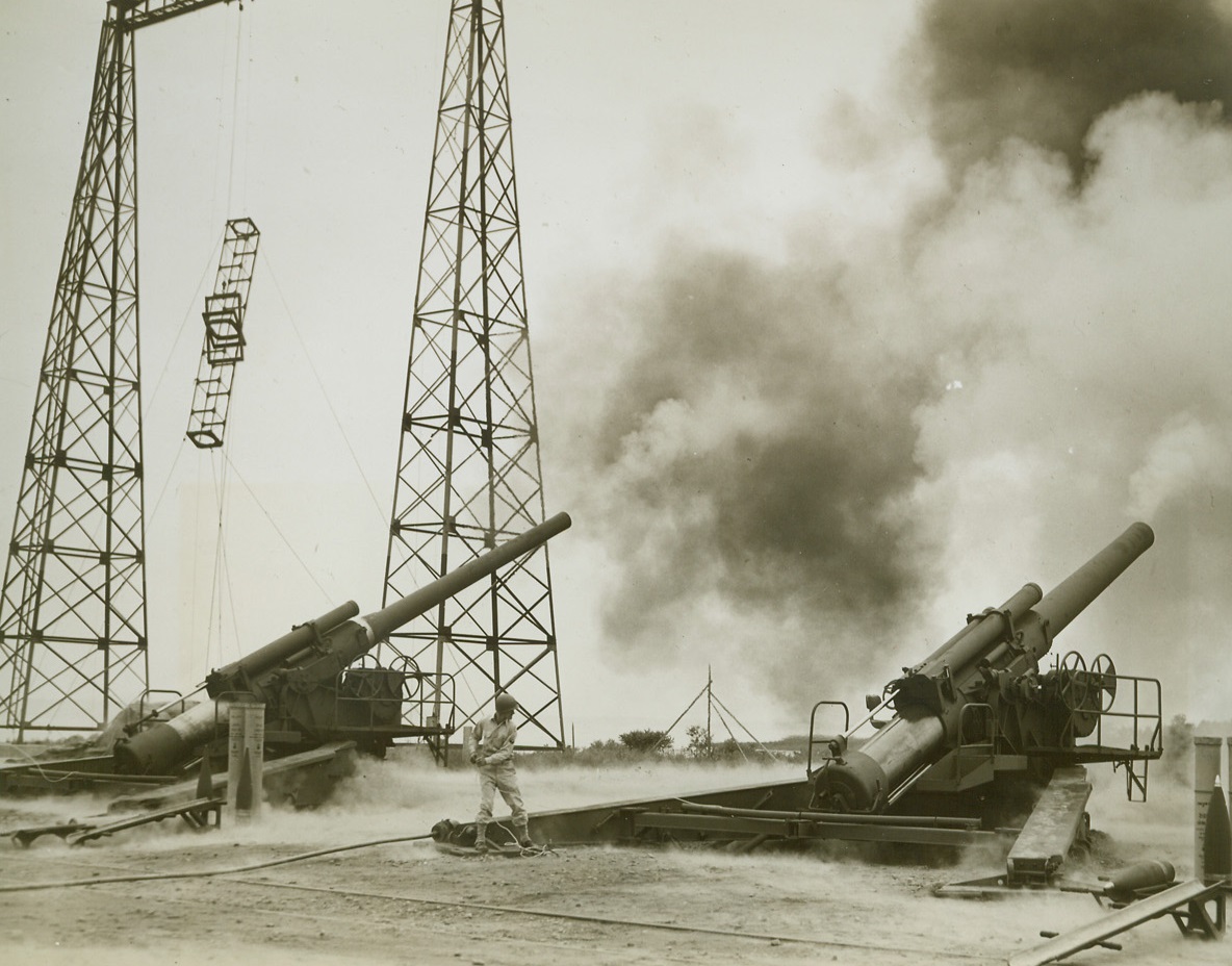 Weapons Tested at Aberdeen Proving Grounds, 9/1/1944.Aberdeen, Maryland -- In a test demonstration at Aberdeen Proving Ground, a 240mm Howitzer (right) and an 8-inch gun fire away amid a dense cloud of smoke from their shells. The test, held on August 29, 1944, demonstrated new weapons that have been developed at the Proving Ground for use by our Armed Forces. Credit: ACME;