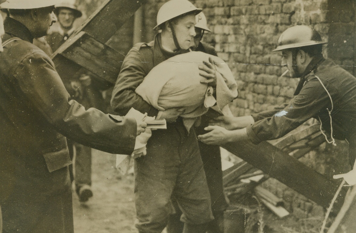 No Title. LONDON, ENGLAND - Body of baby taken from ruins of air raid shelter.;