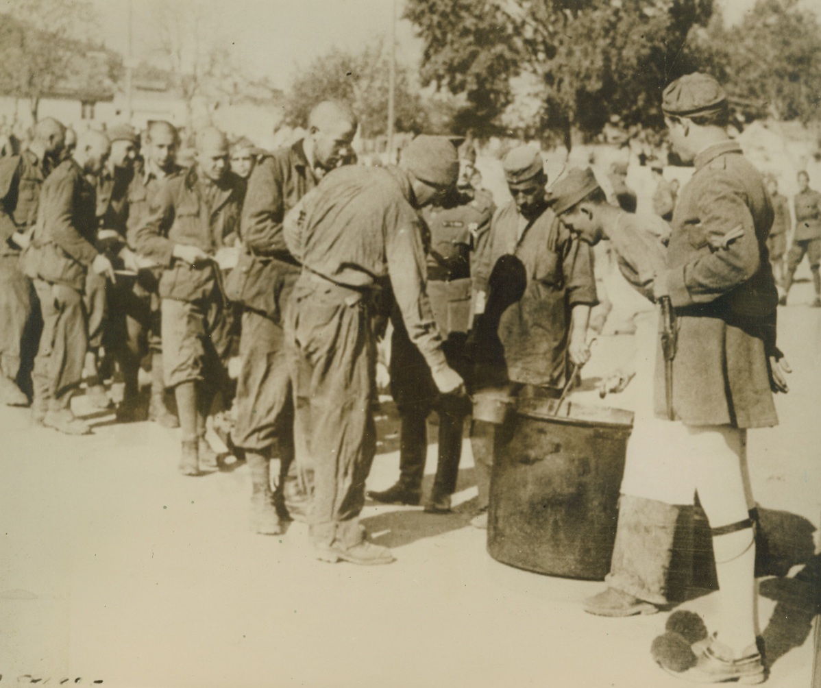SOUP’S ON FOR ITALIAN PRISONERS, 12/27/1940  Anxiously lined up for food are these Italian prisoners—many with heads shaved—shown at an undisclosed Greek internment camp. Thousands of Mussolini’s soldiers have a similar existence. Credit: Acme;