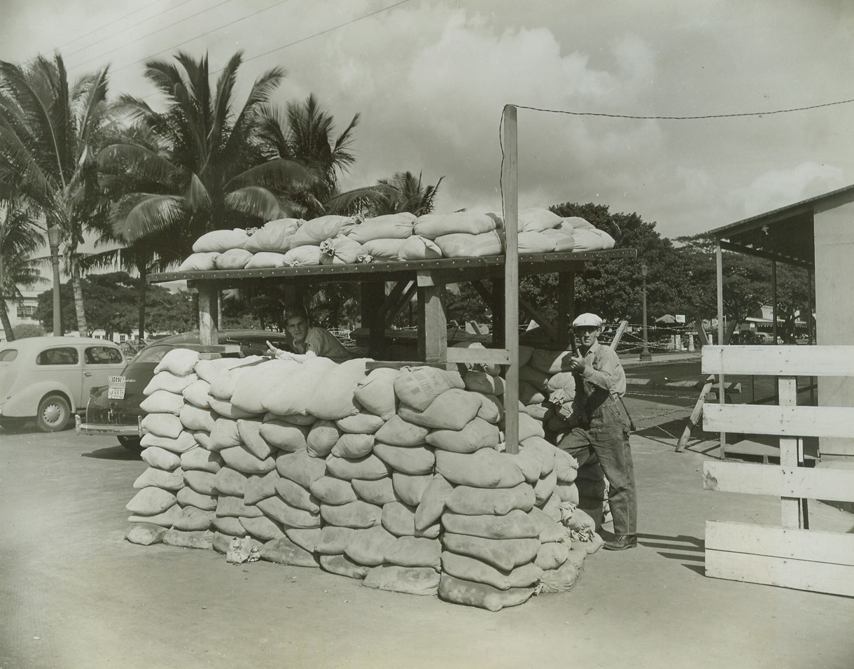 Honolulu’s Utilities Heavily Guarded, 12/31/41  Honolulu, Hawaii – Sand bags, barbed wire and Hawaiian territorial guards around Hawaii’s vital waterfront power plant form an effective defense against the possibility of sabotage or direct attack by parachute troops. Photo by Allan Campbell, ACME staff photographer. Credit: ACME;