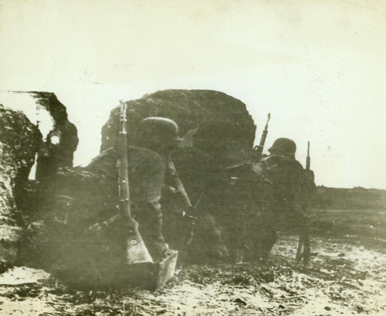 GERMAN ADVANCE IN CRIMEA, 10/29/1941. Under cover of what remains from a house, German troops wait to attack under heavy defensive fire from Russian defenders after breaking thru Soviet front line in the Crimea. Photo passed by German censor and radioed from Berlin to New York today (Oct. 29). Credit (Official German Photo From ACME);