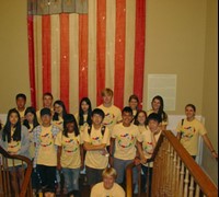 Students pose for a group photo on the stairs at the museum.
