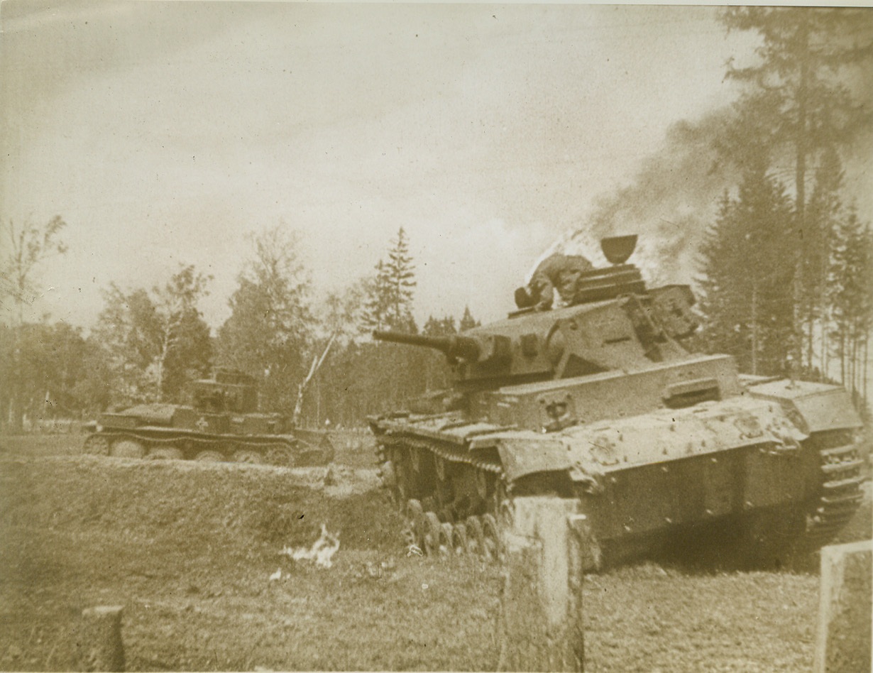 Nazi in Flames, 2/10/1943. ON THE RUSSIAN FRONT -- With flames licking at his uniform, a Nazi soldier tries to crawl from his knocked-out tank somewhere on the Russian front. Recent dispatches from Moscow reveal that the Red Army has taken Belgorod with a smashing blow that perils the chief Nazi base at Kharkov, east of the Dnieper River.  Credit (Copyright March of Time Photo from ACME);