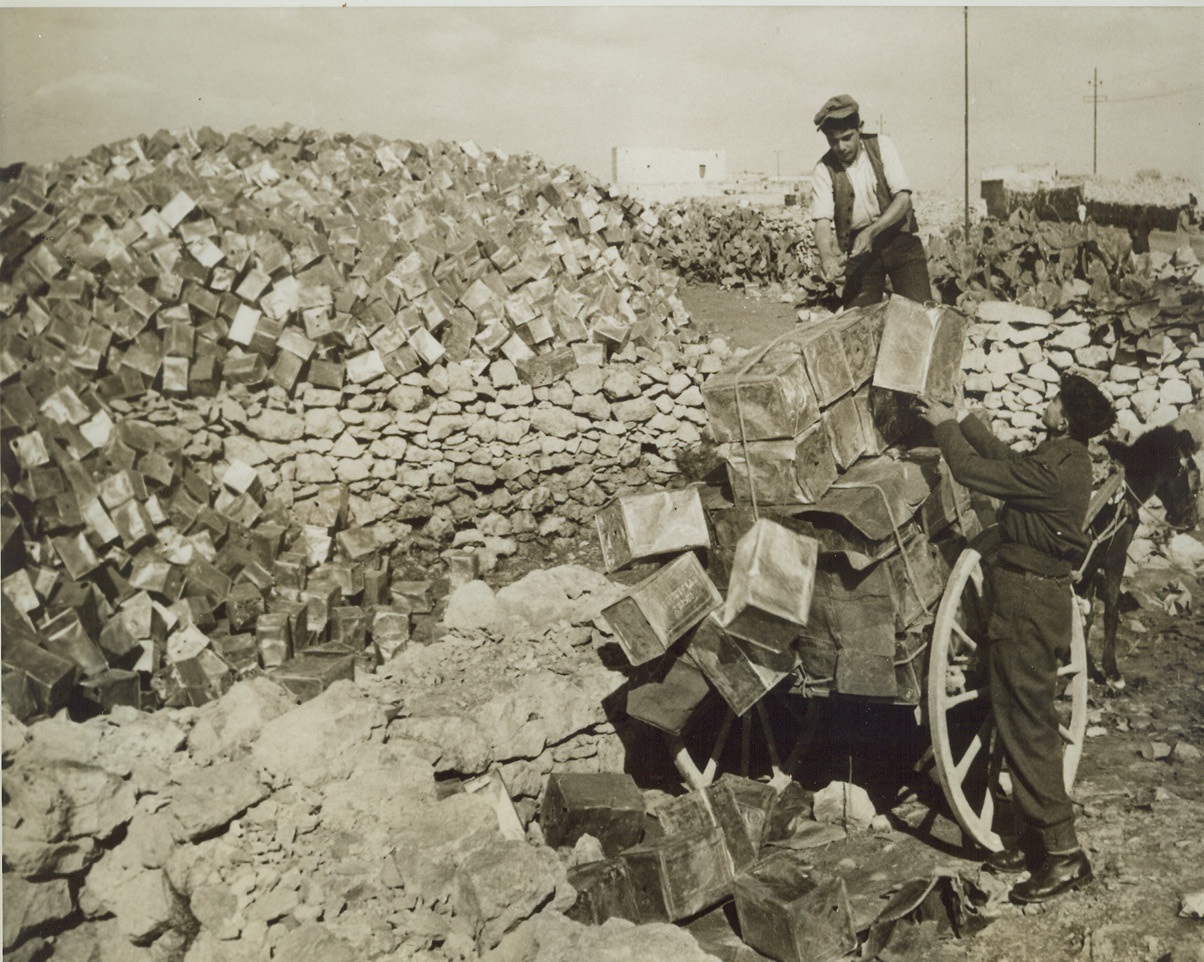 SALVAGE BIN, 2/17/1943.  MALTA—When you take a look at these empty gasoline tins, piled along the edges of Malta’s farms, it’s easy to see that it takes an awful lot of the precious liquid to keep British planes in the air. The empty cans come from nearby airfields and are kept here pending future salvage. Credit: Acme;