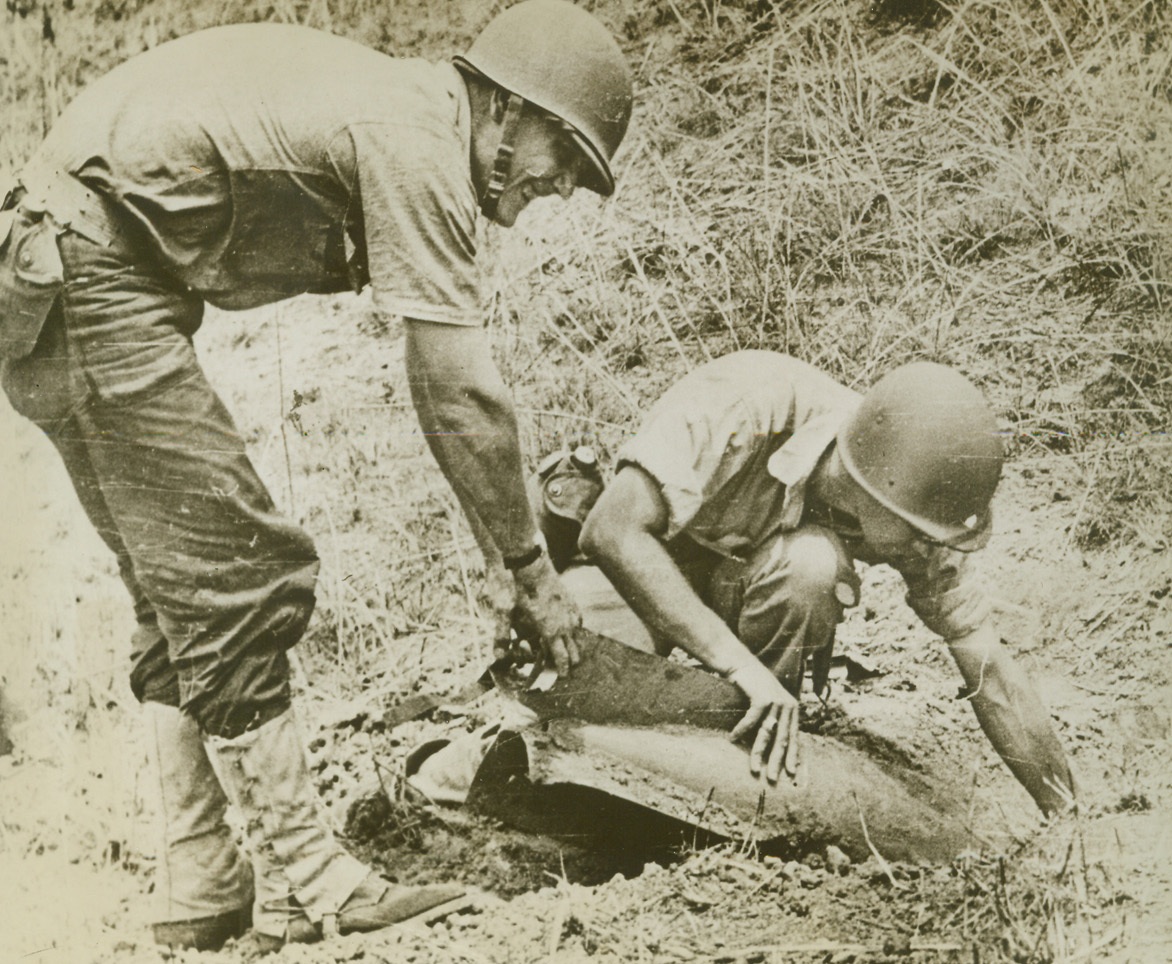 Ticklish Job, 2/5/1943. Guadalcanal, S.I. – U.S. Marines remove a Jap bomb from the ground on Guadalcanal, using extreme care in excavating the dirt around the bomb, for the least jar sometimes sets the bomb off.  After being removed, the bomb is taken apart - - another ticklish job that calls for high technical skill.Credit (U.S. Marine Corps photo from ACME);