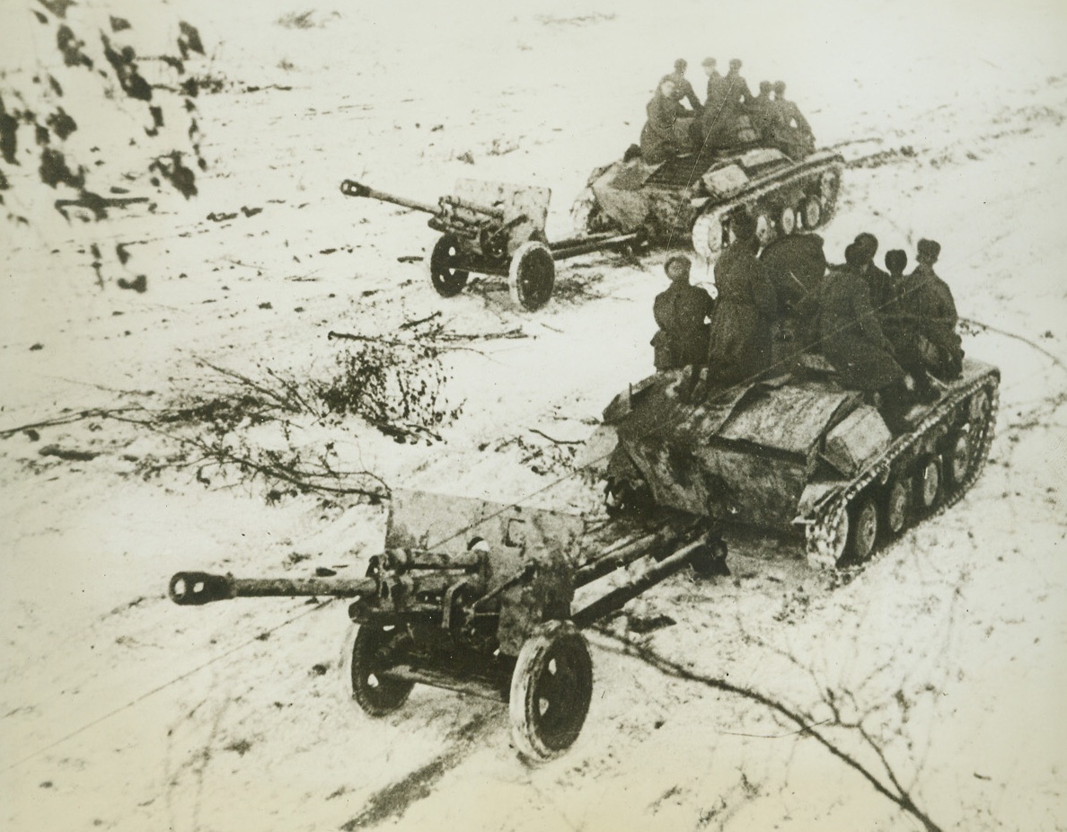 Death Approaches Nazi Tanks, 2/19/1943. Central Front, Russia – Soviet Anti-Tank Guns, accompanying Tanks, move up on the Central Front to reinforce the rapidly advancing Red troops. Even the Russian Infantry is now using “tank tactics” as it virtually rolls over floundering Nazis. Credit: ACME;