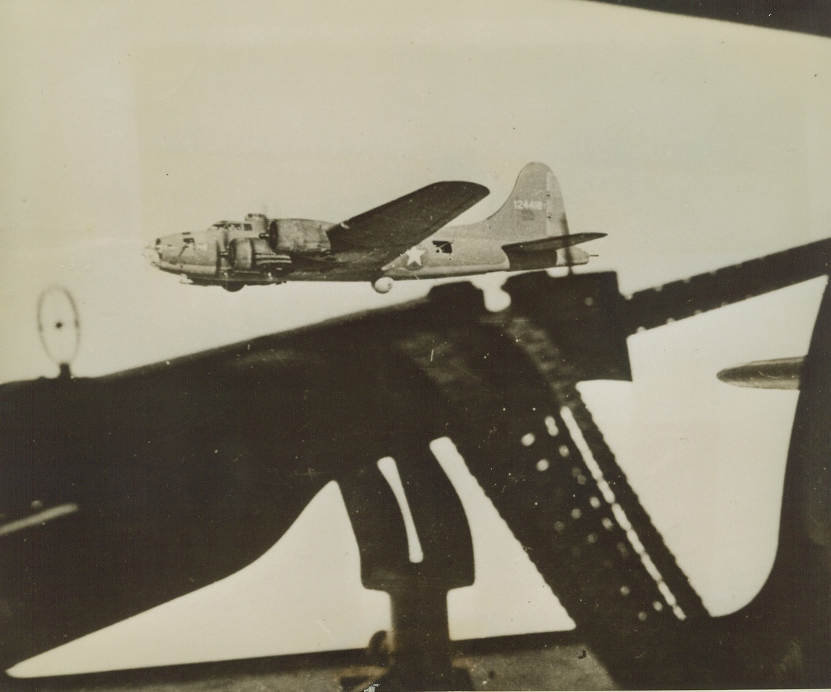 Line Up for Attack, 2/14/1943. Tunisia – Seen from the waist gunner’s position in a sister plane, this bomber prepares to line up, wing to wing, with other flying fortresses participating in an attack on the Tunisian front, early this year.  Nineteen German fighters were downed in the resulting sortie – the biggest air battle of the Tunisian front to date.  Latest reports from Tunisia indicate that the British 8th Army has blasted Rommel out of his first defense line in South Tunisia. Credit line is not visible.;