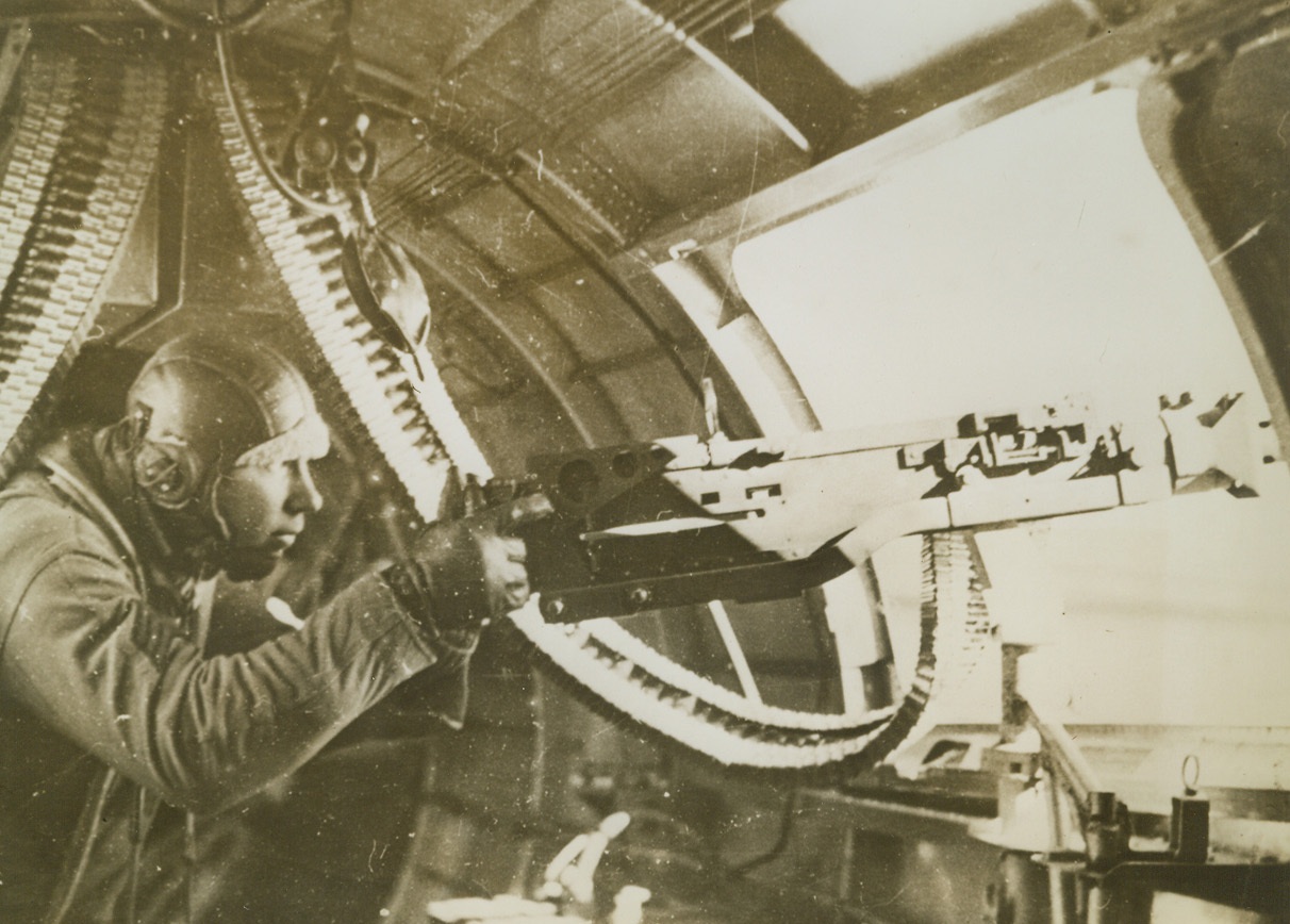 Gunner In Action, 2/14/1943. Tunisia – Waist gunner Robert L. Doremus of Henrietta, Okla., goes into action as enemy fighters approach to attack his fortress.  The 20-year-old gunner was the hero of the operation during which photo was made – the biggest air battle over Tunisia to date.  Gunner Doremus’ guns were going all the time, and 19 enemy fighters were sent down during the battle.  Latest reports received from Tunisia indicate that the British 8th Army has blasted Rommel out of his first line of defense in South Tunisia.Credit line (ACME);