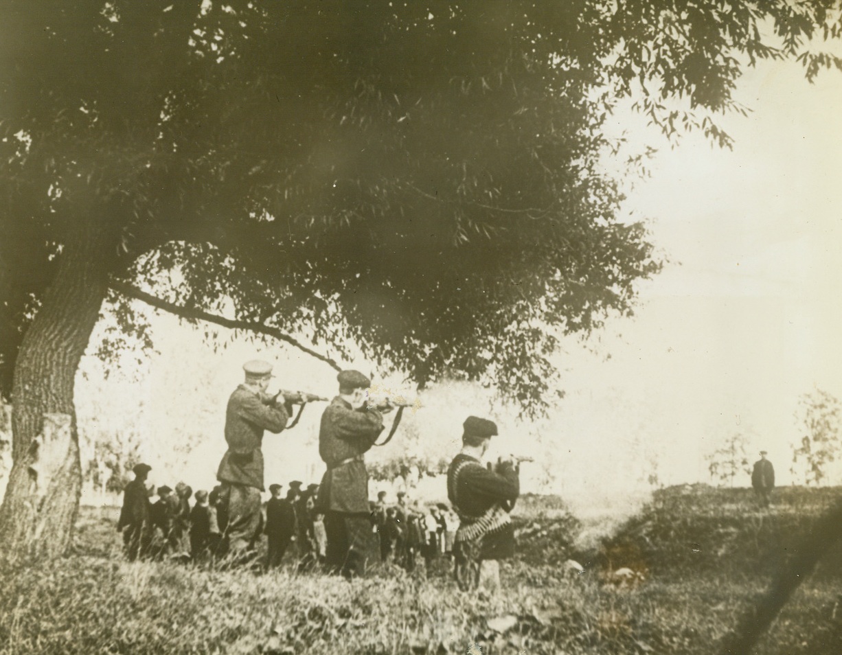 The End of a Traitor, 2/10/1943. On the Russian Front—Before a jeering crowd of men, women and children of a Russian village a red “Quisling” is executed by a firing squad. Photo is part of March of Time’s documentary film, “One Day of War—Russia, 1943,” which depicts the action along the vast Russian front in a single day. Latest reports from Moscow indicate that Soviet forces have taken the hugh Nazi base and railroad center at Belgordd. Passed by censors. Credit: Copyright March of Time photo from ACME.;