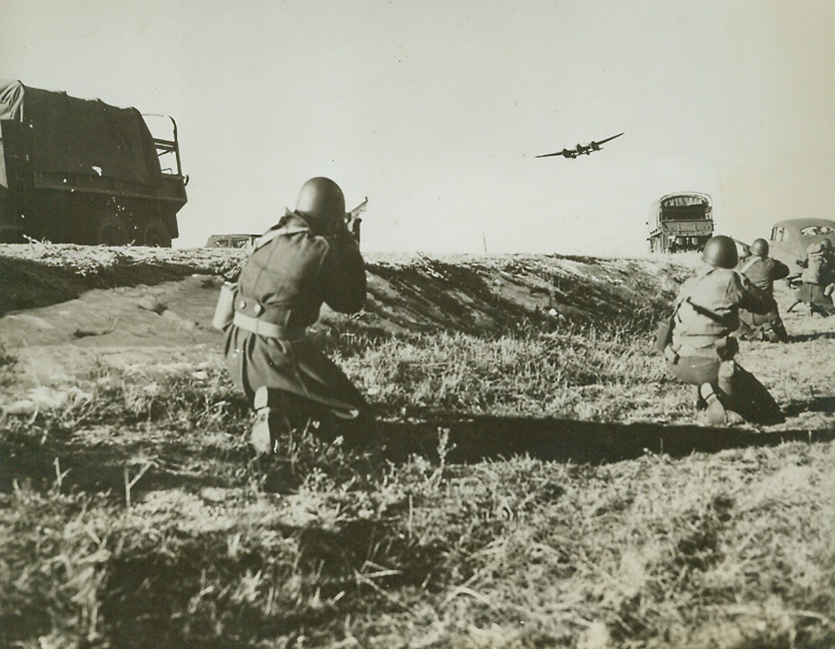 A War of Supplies, 2/5/1943.  Fort Warren, Wyoming—Fighting quartermasters, at OCS school, break for the bush and “open fire” on low-flying planes that are trying to prevent their getting supplies up Icy Pole Mountain near Fort Frances E. Warren, Wyoming. The school instructors man the planes and try in every way to obstruct the successful movement of supplies in a mock battle. Despite wily attempts to demoralize them and harass movements with simulated air, gas, and mechanized attacks, the students—who will soon be important links in America’s battle for victory—all got their supplies through.Credit: ACME.;