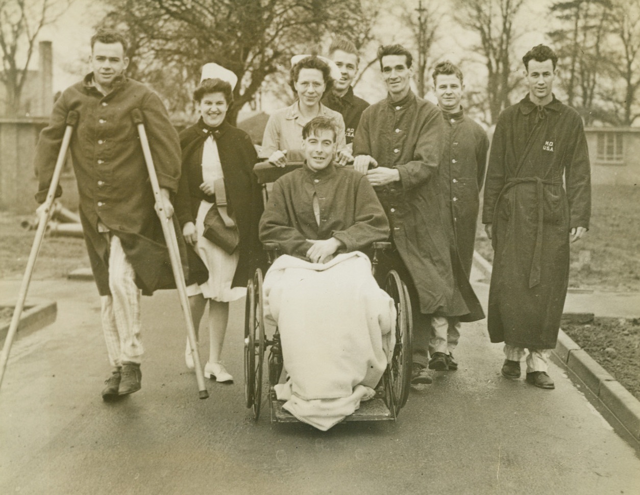 Doin’ Fine, 2/17/1943. Somewhere in Britain - Convalescing in a West Country Hospital, British and American soldiers, accompanied by American nurses, take a stroll on the hospital grounds. All well on the way to recovery, the men were brought to Britain after being wounded on North African battlefields. Passed by Censors Credit: ACME;