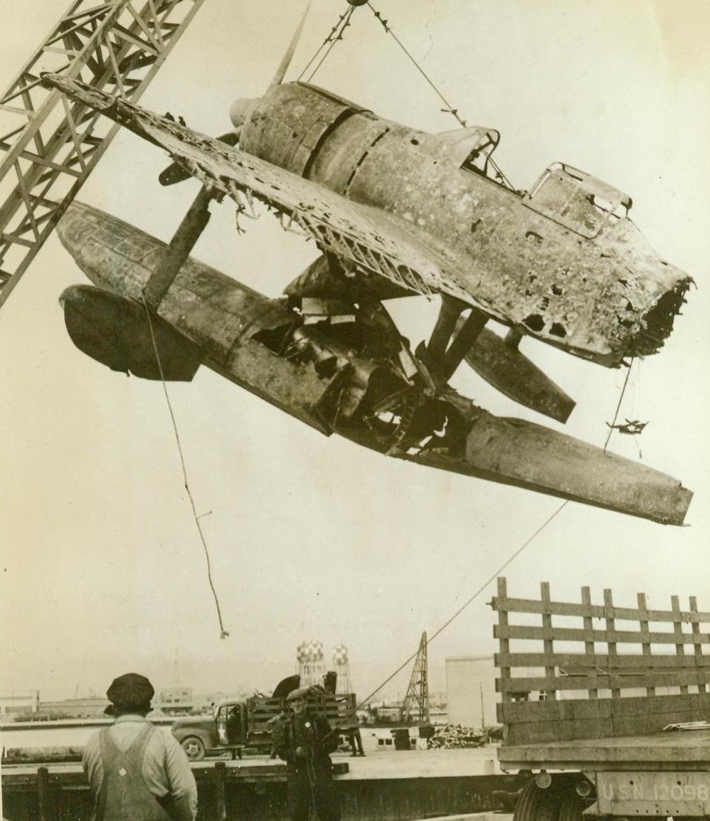 Blasted Zero Brought To U.S. For Inspection, 2/26/1943. Alameda, Calif. – A Jap zero float-type plane, brought down by U.S. forces in the Pacific, is unloaded at Alameda. The Navy Department will inspect the plane as well as other enemy aircraft, blasted in the Pacific zone and transported to the United States. 2/26/43 (ACME);