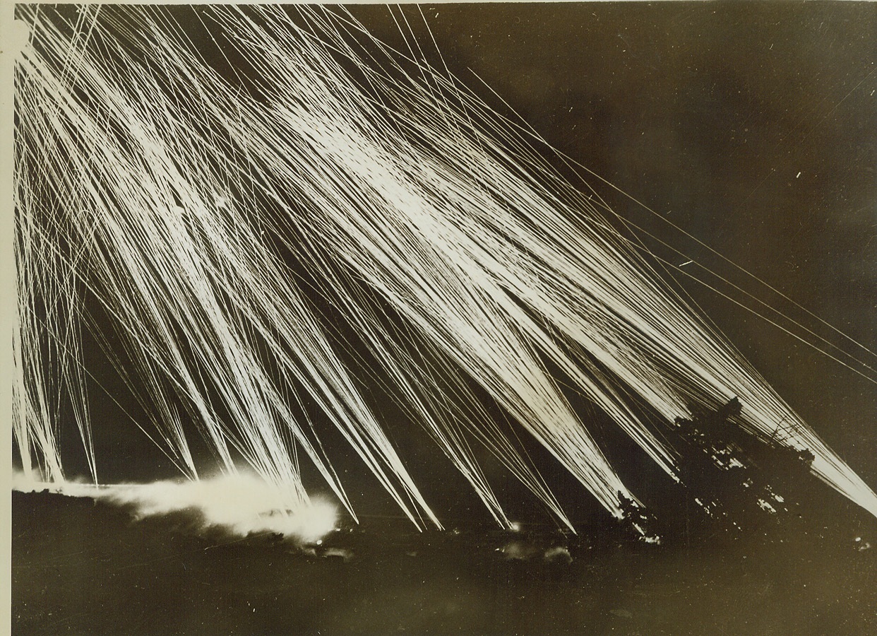 Pillar of Fire Against Foe, 3/2/1943. Algiers – Enemy planes which recently raided Algiers were met by this veritable wall of fire sent up by a massed battery of anti-aircraft guns. Needless to say, few Axis planes broke through. Credit: (ACME);