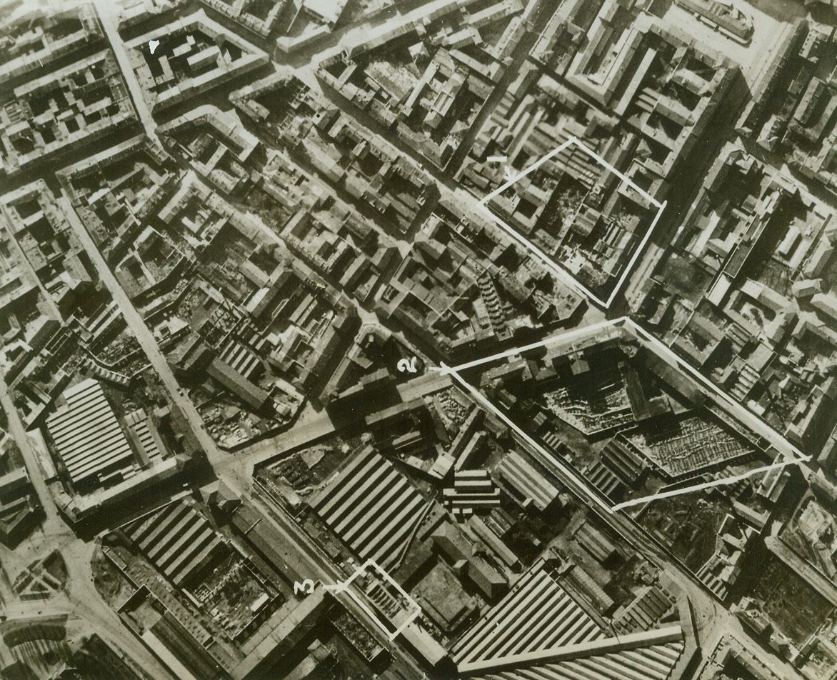 Bombed Milan, 3/24/1943. MILAN, ITALY – This low aerial photo clearly shows the damage resulting from R.A.F. raid on the night of February 14/15. Outlined areas show: (1) Destruction by high explosive of industrial buildings in Via Paolo Lomazzo, (2) two sheds destroyed and another partly gutted in elastic manufacturing establishment in Via Paolo Lomazzo, (3) Recently repaired building of Municipal Tram Depot in Via Messina again damaged.Credit Line (ACME);
