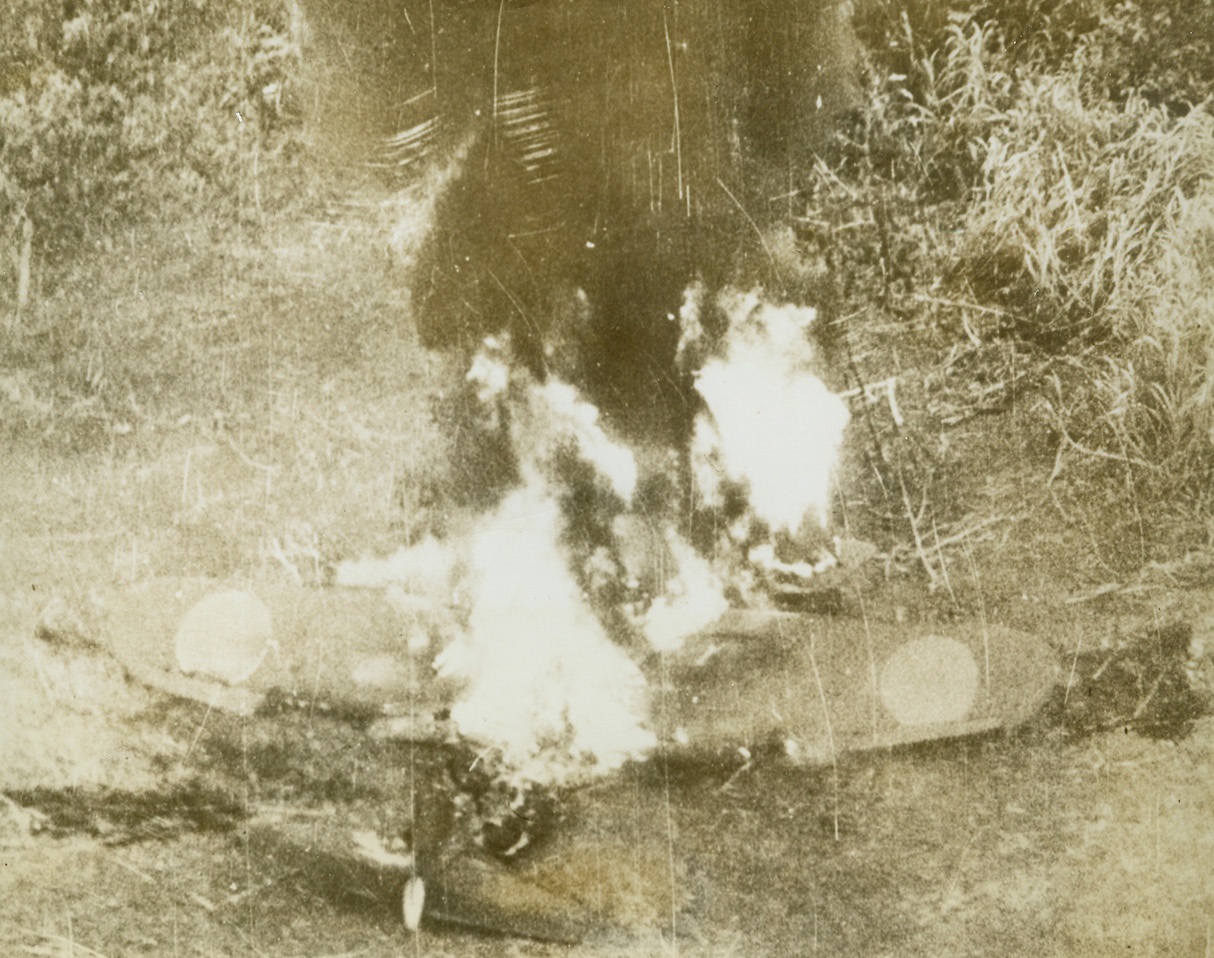 “SCRATCH ONE ZERO!”, 3/23/1943. This photo, taken during the Battle of the Bismarck Sea, shows a Jap Zero plane, caught on the ground at Lae, New Guinea, by Allied bombers, as it burns fiercely. Picture was taken from a RAAF plane flying close to the ground. In the battle, the Allies wiped out a convoy of 22 Japanese ships. Credit: U.S. Army Air Forces photo from Acme;