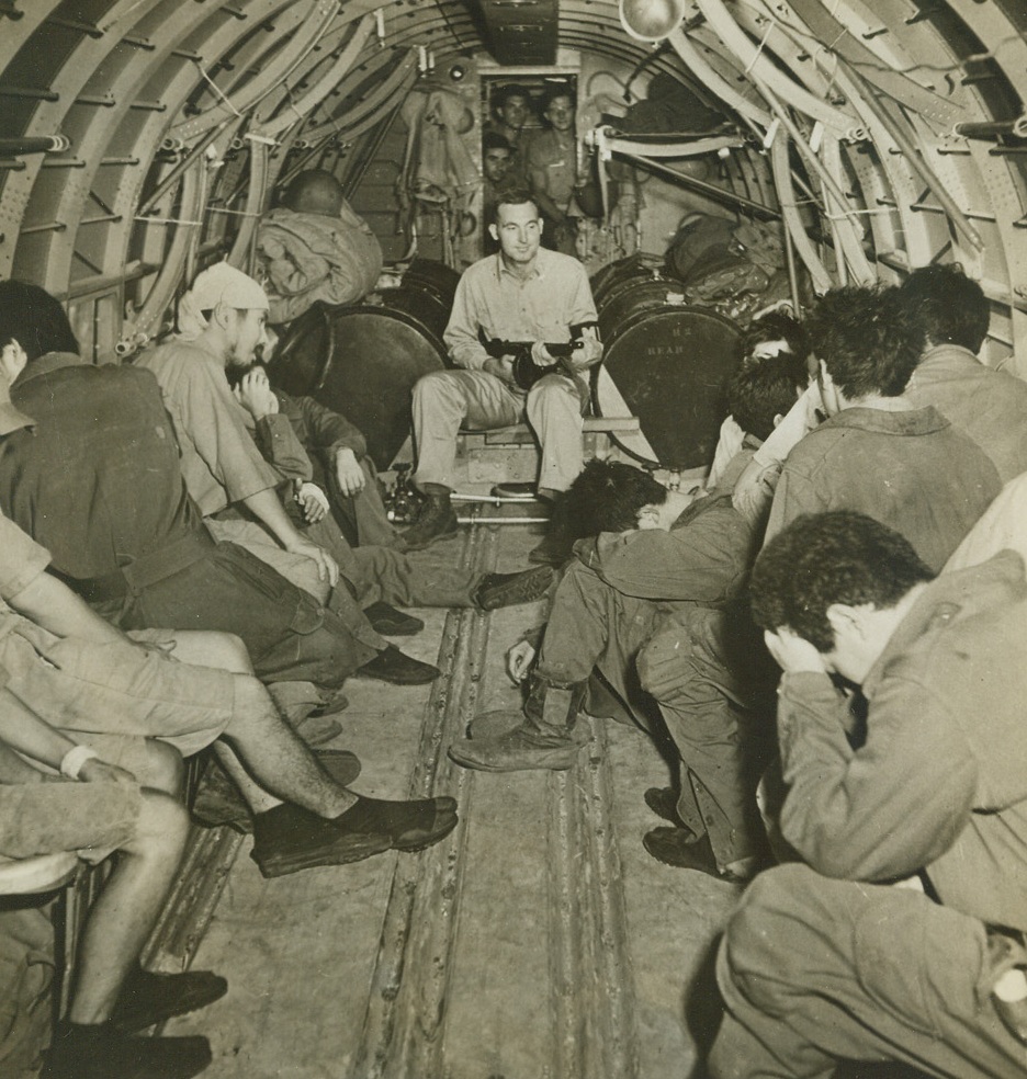 LAMENTING THEIR FATE, 3/7/1943. SOUTH PACIFIC—Japanese airmen and sailors bow their heads as they seem to lament their fate of being prisoners of war. They were captured by the natives on one of the outer islands of the Solomon group and were brought to Guadalcanal by plane, motor torpedo boat and landing boat. From there they were flown to USA headquarters in the South Pacific. Credit: ACME.;