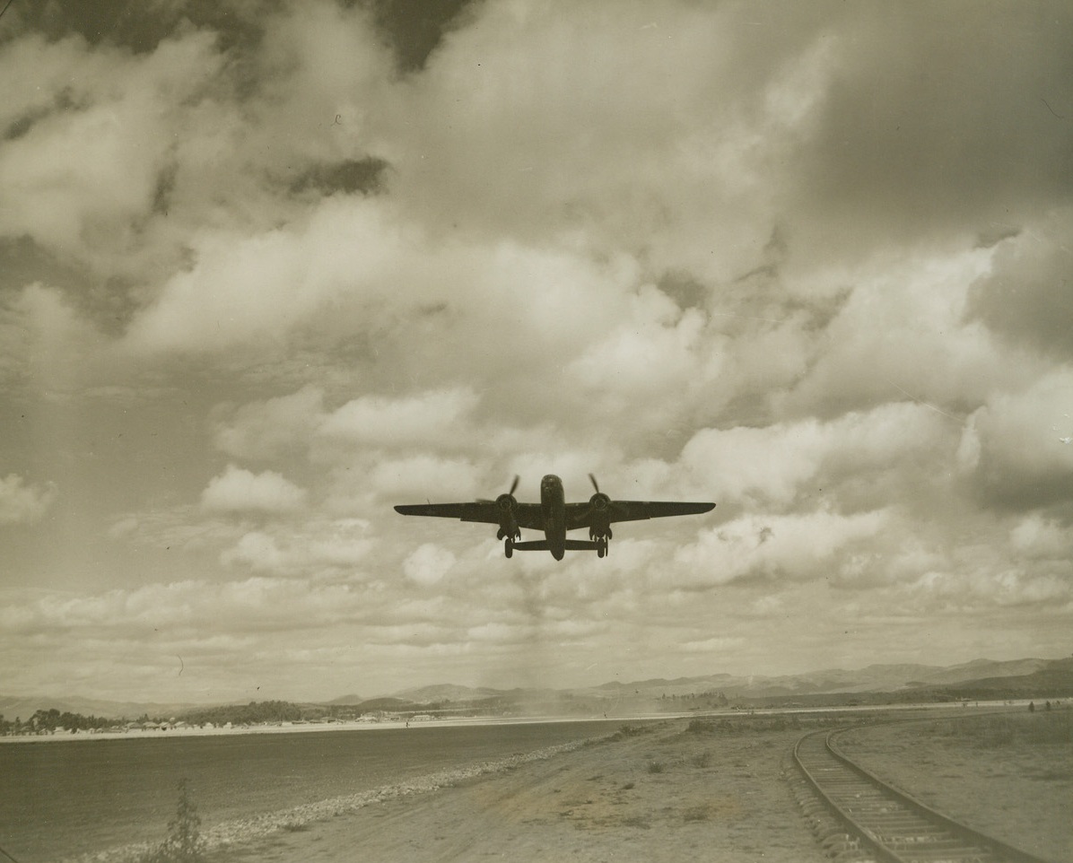 OFF ON A BOMBING MISSION, 3/14/1943. SOMEWHERE IN CHINA—A powerful B-25 leaves clouds of dust behind as it takes off on a bombing mission in the China Air Task Force. The bombers in the task force drop their “eggs” over Burma and occupied cities in China. Credit: ACME.;
