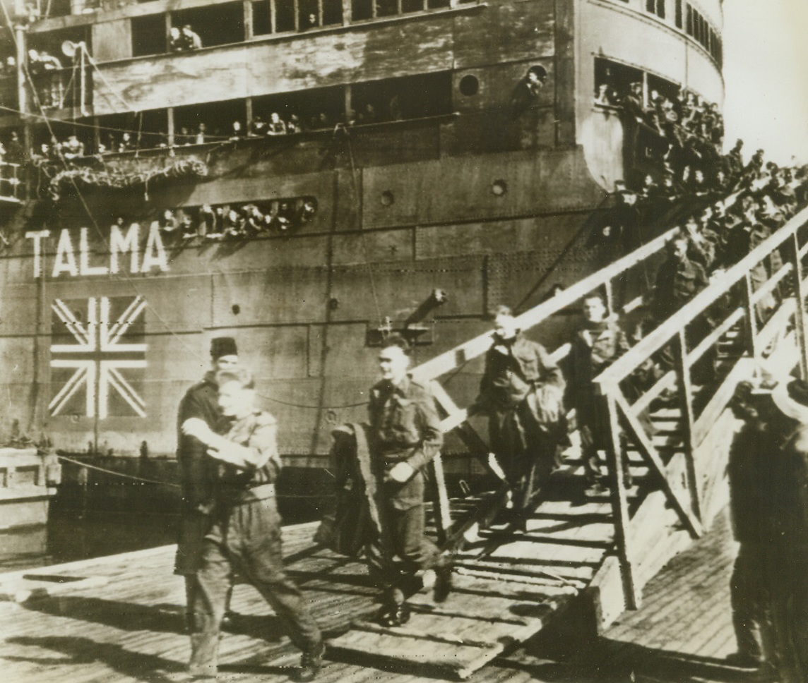 Prisoners of War Are Free Again, 3/25/1943. Middle East Port – Repatriated British soldiers walk down the gangplank from the British ship Talma at a Middle East port.  They were parties to the biggest exchange of able-bodied prisoners in the war as 707 British soldiers were exchanged for 863 Italians and Germans at Mersin, Turkey, on March 21st. Credit line (ACME radio photo);