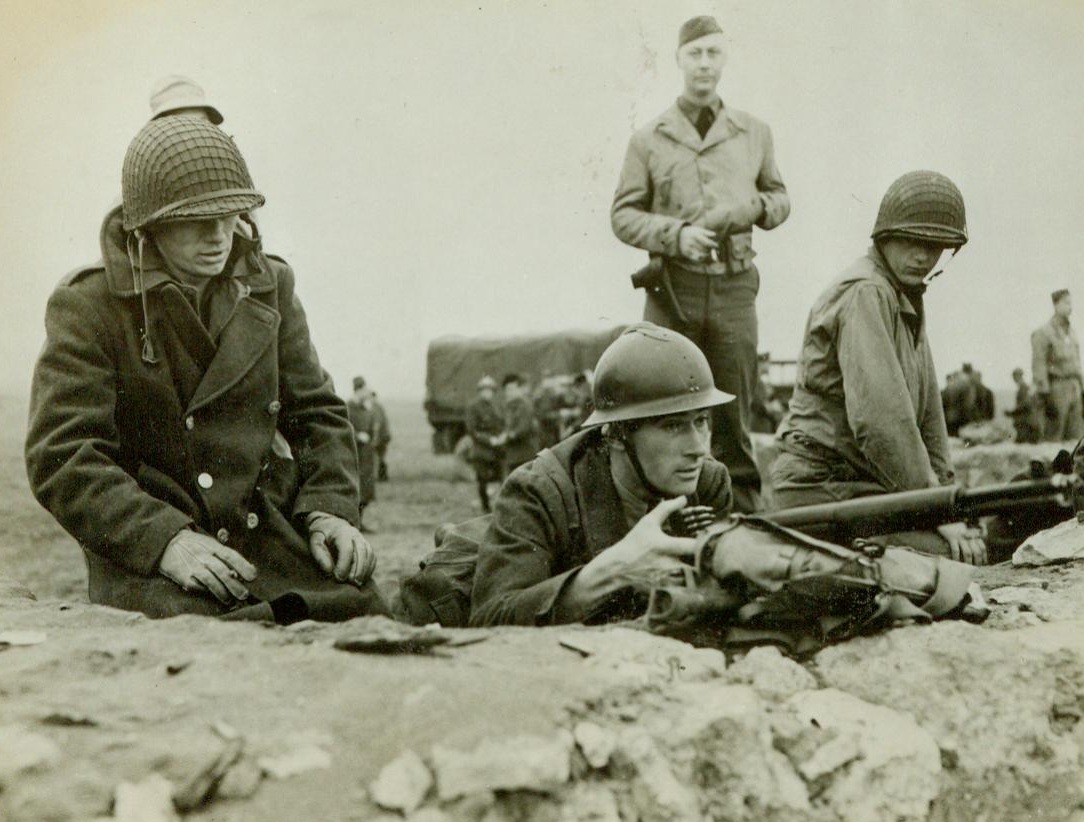 French Learn to Use American Guns, 3/13/1943. Algiers -- Three American soldiers watch as a French Poilu takes his test in the use of a Garand rifle on a range near Algiers. French army officers and men in North Africa are now being taught how to use various U.S. Army weapons and equipment so that they can operate in the African theatre with American-supplied material. Credit: U.S. Army Signal Corps photo from ACME;