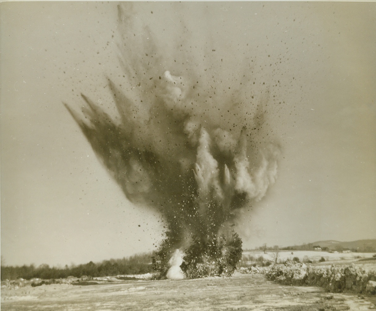 “Bomb” Damages Runway, 3/3/1943. WESTOVER FIELD, MASS. – For the benefit of air borne engineers training at Westover Field, a bomb explosion is simulated on a stabilized earth runway. When the “bombing” is reported, the engineers immediately load their miniature equipment into planes and set out to repair the damage. Credit: (ACME);