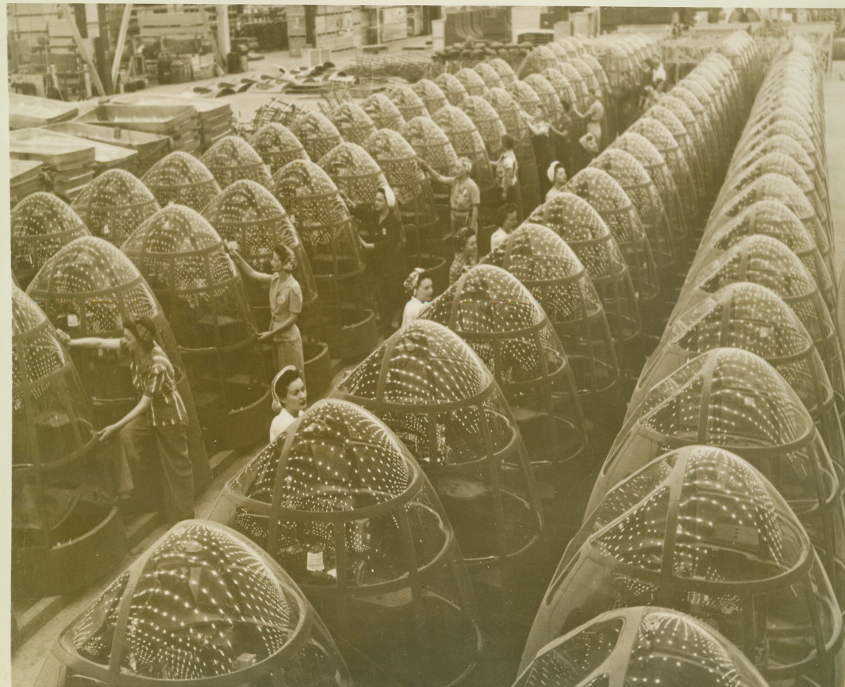 Round the Clock Birth of American Air Power, 3/15/1943. Not only are these Douglas aircraft women workers unconcerned about the shininess of their own proboscises, but their official job is to put a high shine on the noses of planes. Soon, the factory lights reflected in the plexi-glass plane noses will be replaced by foreign stars and the brighter flashes of a wartime sky.  Credit: ACME;