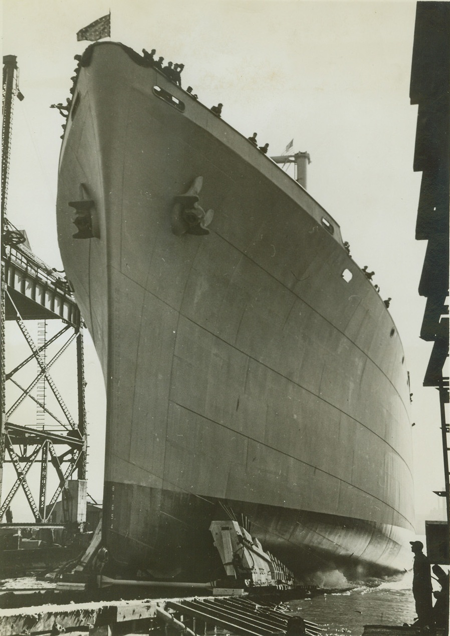 Named for Blue Ridge Mts., 3/7/1943, Kearny, N.J.—Sliding down the ways at Federal Shipbuilding and Dry Dock Company’s Kearny Shipyards, the U.S.S. Blue Ridge is one of the first two naval vessels to bear the name of an American mountain. The other ship, the U.S.S. Rocky Mt., was launched at the same time. Both are converted C-2 type cargo vessels, which will be assigned for special Navy duty. Mrs. David Arnott, wife of the Vice President and Chief Surveyor of the American Bureau of Shipping, sponsored the Blue Ridge at today’s (March 7) ceremonies, while Mrs. Robert C. Lee, wife of the president of the Propellor Club of the U.S., sponsored by the Rocky Mt. Credit: ACME.;