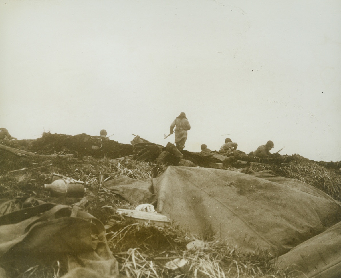 First Photos of Yank Landing on Attu, 5/26/1943. Washington, D.C.- - This photo, one of the first taken of the landing of U.S. troops on Jap-held island last May 11th, was taken by a Navy combat photographer and released in Washington today. Cameramen who took these photos of the landing at two points on the island, Massacre Bay and Holtz Bay, were under Jap fire many times. Here, U.S. troops advance in the face of enemy fire. This is a front line shot made just as a bank of fog came rolling in. While this photo was taken, Jap bullets were singing by.Credit Line (U.S. Navy photo from ACME);