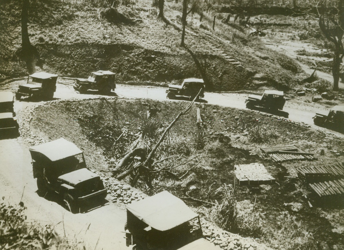 THE WINDING WAY TO BURMA, 5/21/1943. BURMA—A convoy of jeeps moves slowly along the narrow, winding road to Burma, to carry supplies to Allied troops stationed there. Built by the Army in less than six months, the road is a slender ribbon, twisting through miles of mountains, jungles, and thick forests. In the discussions of long-range Pacific strategy now under way in Washington, Burma is most likely the center of attention, for it is the key to China,  through which the attack on the empire of Japan must be made. This small supply route must serve Allied forces until the Japs can be knocked out of Burma and the Burma road reopened. Credit: ACME.;