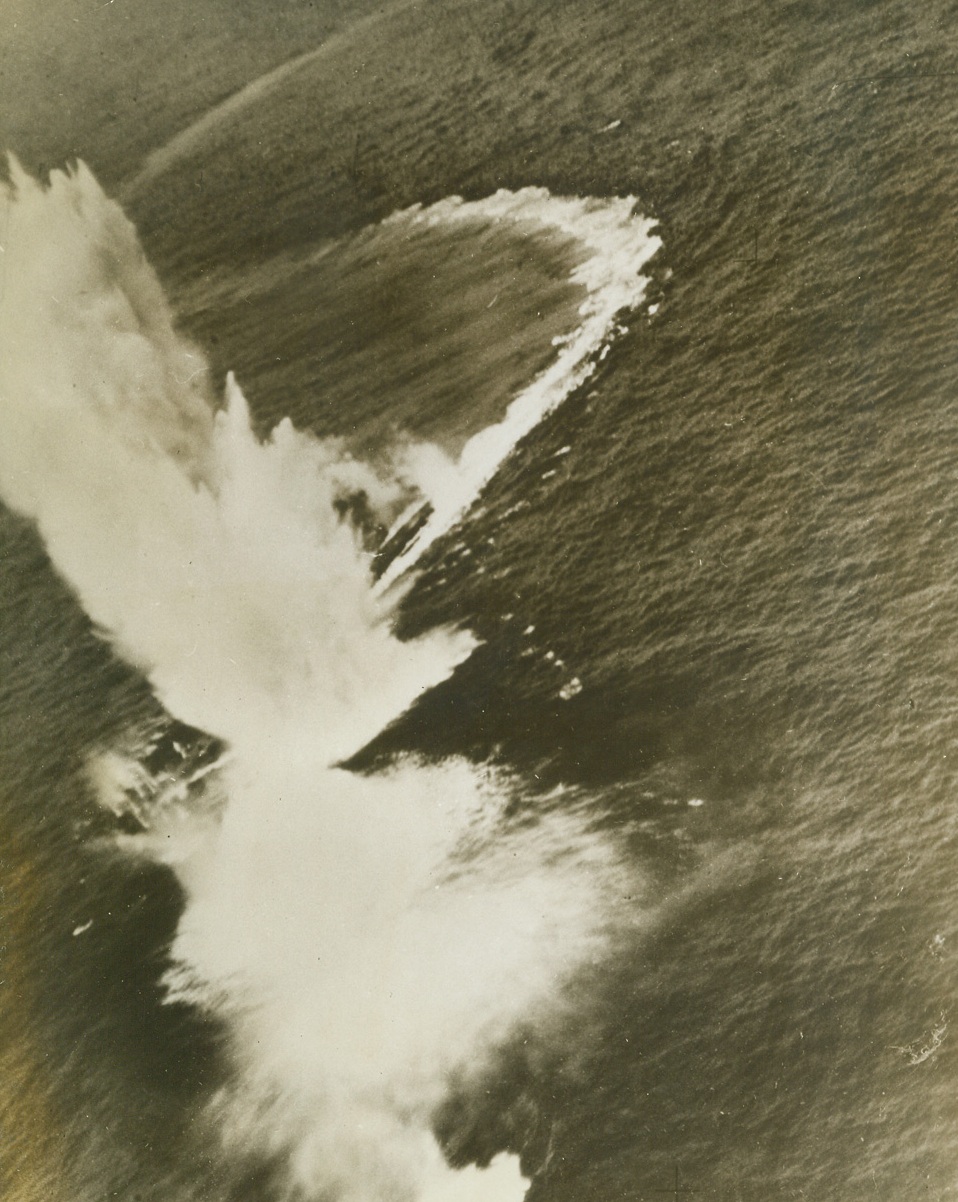 DANGEROUS CURVES AHEAD!, 6/10/1943. BAY OF BISCAY—This enemy submarine, damaged and unable to crash dive, went into a wild series of “S” curves to avoid bombing attack by two Sunderland flying boats of an Australian Squadron, only to run smack into a group of bombs from one of the planes. The Sunderlands were on patrol over the approaches to the Bay of Biscay when they spotted the U-boat. They attacked immediately, damaging the sub on the first run. Then they came in for the kill. A few moments after the above photo was taken, stern of the sub protruded from the water at a steep angle then disappeared from sight in a mass of bubbles. Several sailors were seen in the water as the U-boat went to its grave. Credit: Acme;