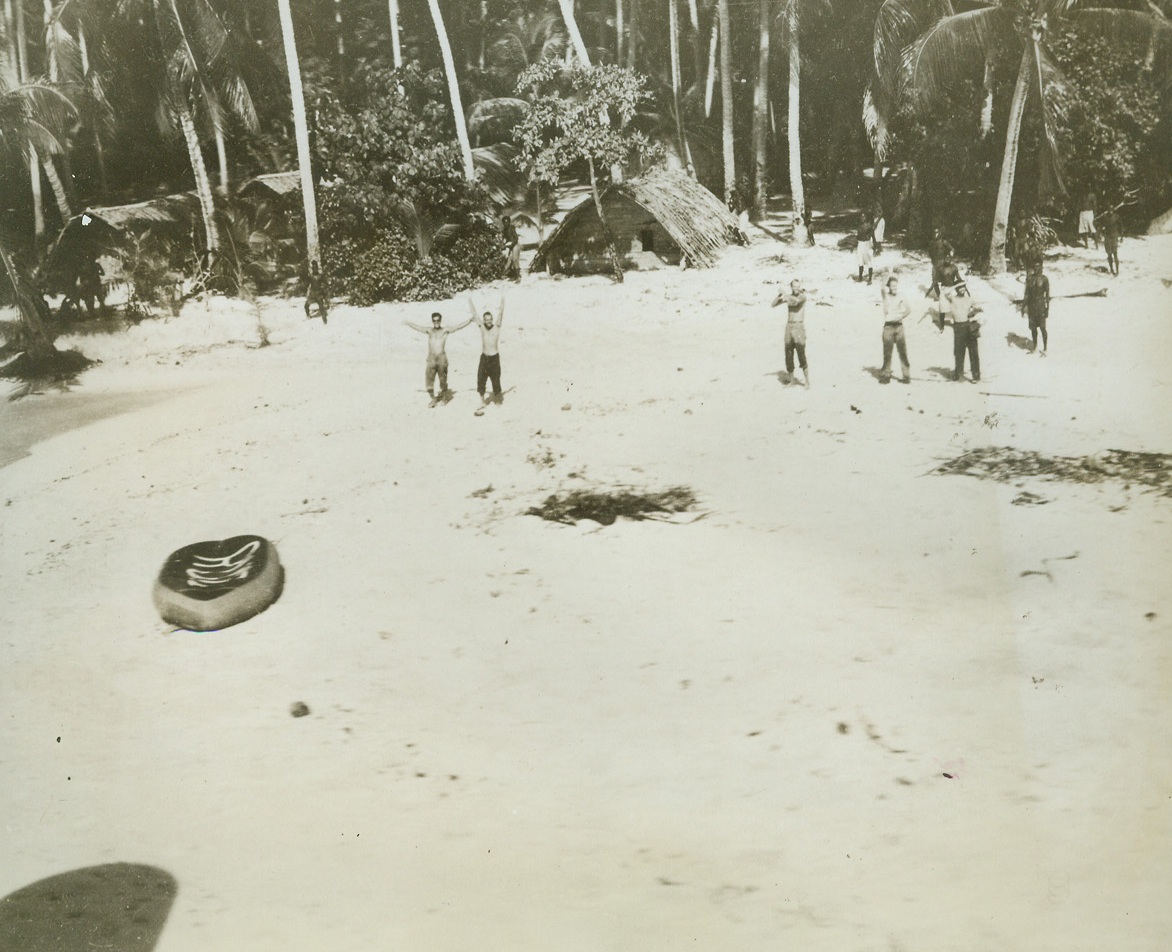 JOYOUS MOMENT, 6/19/1943. SOMEWHERE IN THE SOUTH PACIFIC—After being marooned on this island for 66 days, members of a B-17 crew leap and wave for joy as their long-awaited rescue plane flies overhead. A moment before photo was made, the beach was deserted as the men and natives hid while deciding whether the plane was friend or foe. Natives still hug the fringe of a palms as the men rush out. Left to right: M/Sgt. Donald O. Martin of Decatur, Ill.; T/Sgt. William H. Nichols of Keiser, Ark.; T/Sgt. Robert J. Turnbell of San Antonio, Texas; First Lt. Ernest C. Ruiz of Santa Barbara, Calif. Note the fliers’ raft on beach. Shadow in lower left corner was made by rescue plane’s wing.  Credit: OFFICIAL ARMY AIR FORCES PHOTO-ACME.;