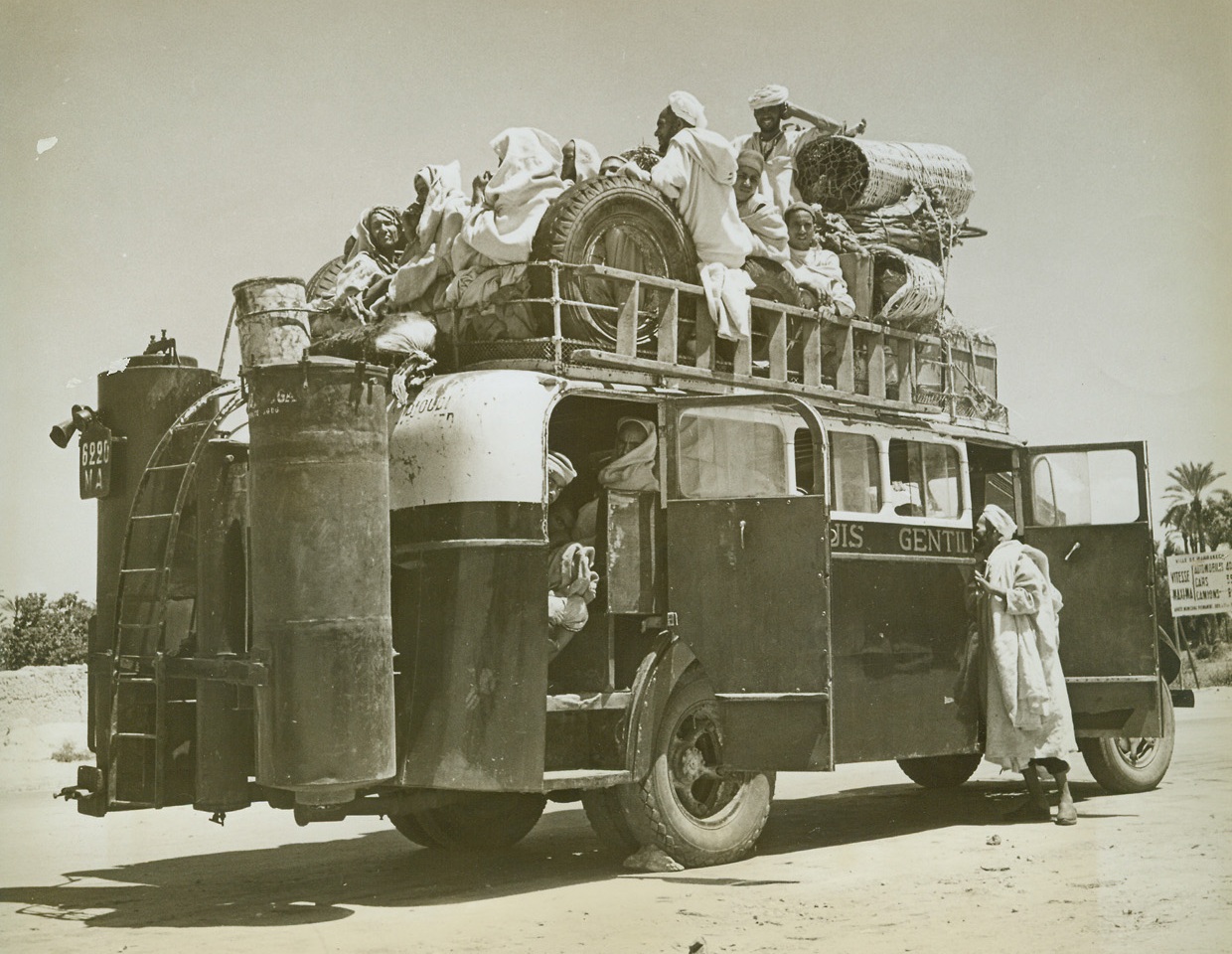 Up and Over, 6/4/1943. French Morocco - - Topside and below deck, natives of Marrakech crowd the bus that travels the main highway.  Their belongings, too, take up a large share of the space on the strange vehicle that furnishes transportation on the outskirts of the French Moroccan town.Credit line – WP – (ACME;
