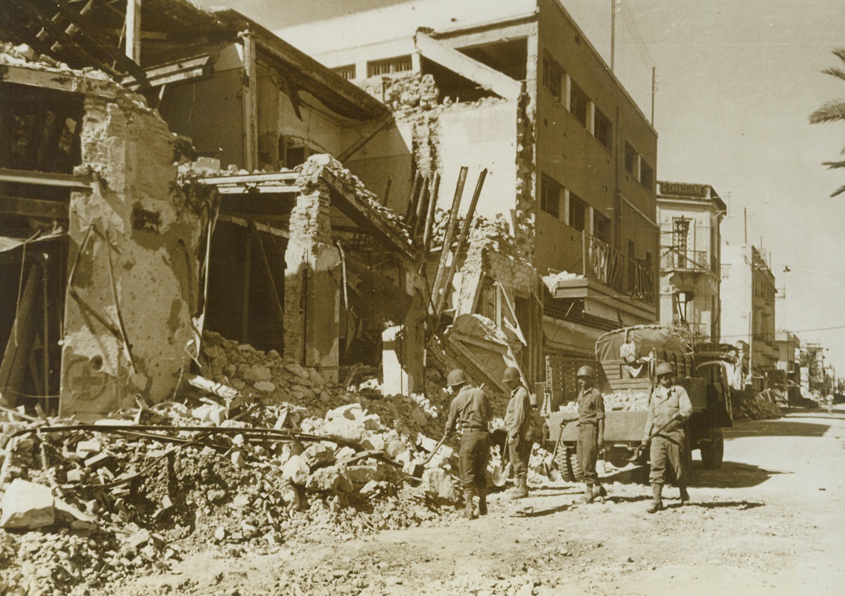 Clearing Up Bizerte, 6/5/1943. Tunisia – Armed with shovels, American engineers go about the important task of clearing rubble from the streets of Bizerte in the aftermath of allied victory.  Buildings were ruined in the bombings that helped force the axis retreat and final defeat in Tunisia. Credit line – WP – (ACME);