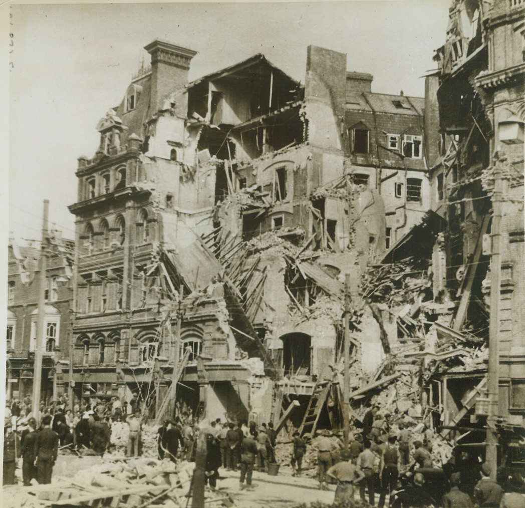English Hotel Hit in Nazi Nuisance Raid, 6/3/1943. ENGLAND -- Soldiers and civilian defense workers search the wreckage of a hotel in a south coast English town, hit in a recent nuisance raid by Nazi planes. Stores, hotels and a cinema were hit in the raid. In this hotel, (above), there were several casualties. Credit: (ACME);