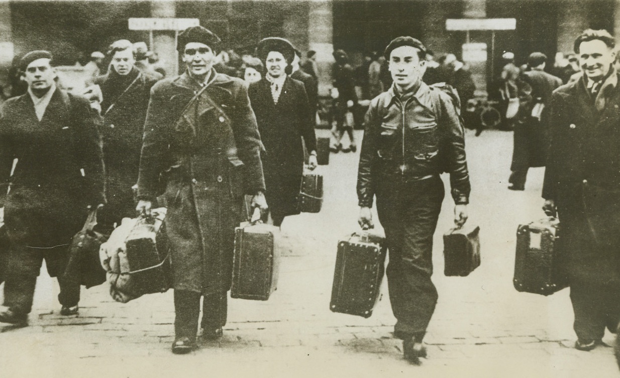 Temporary Freedom, 6/14/1943. Paris—Their bondage temporarily lifted, a group of French workers arrive in Paris on a “short leave” from their compulsory war jobs in Germany. The vacations were ordered as an inducement to other Frenchmen to work for the Nazi war effort in Germany. Laval has been unable to obtain enough slaves for Hitler, and every means is being used—unsuccessfully—to obtain volunteers. Credit: ACME.;