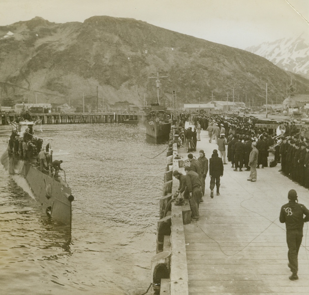Strike Up the Band, 6/16/1943. Dutch Harbor, Alaska -- The Navy Band was right on hand to strike up a merry tune and give this American submarine a rousing welcome as she made her way into port. There was good reason for the festivities, for the overseas fighter has sent five Jap ships--two merchantmen and three men-of-war, to the bottom of the Pacific. Credit: Official U.S. Navy photo from ACME;