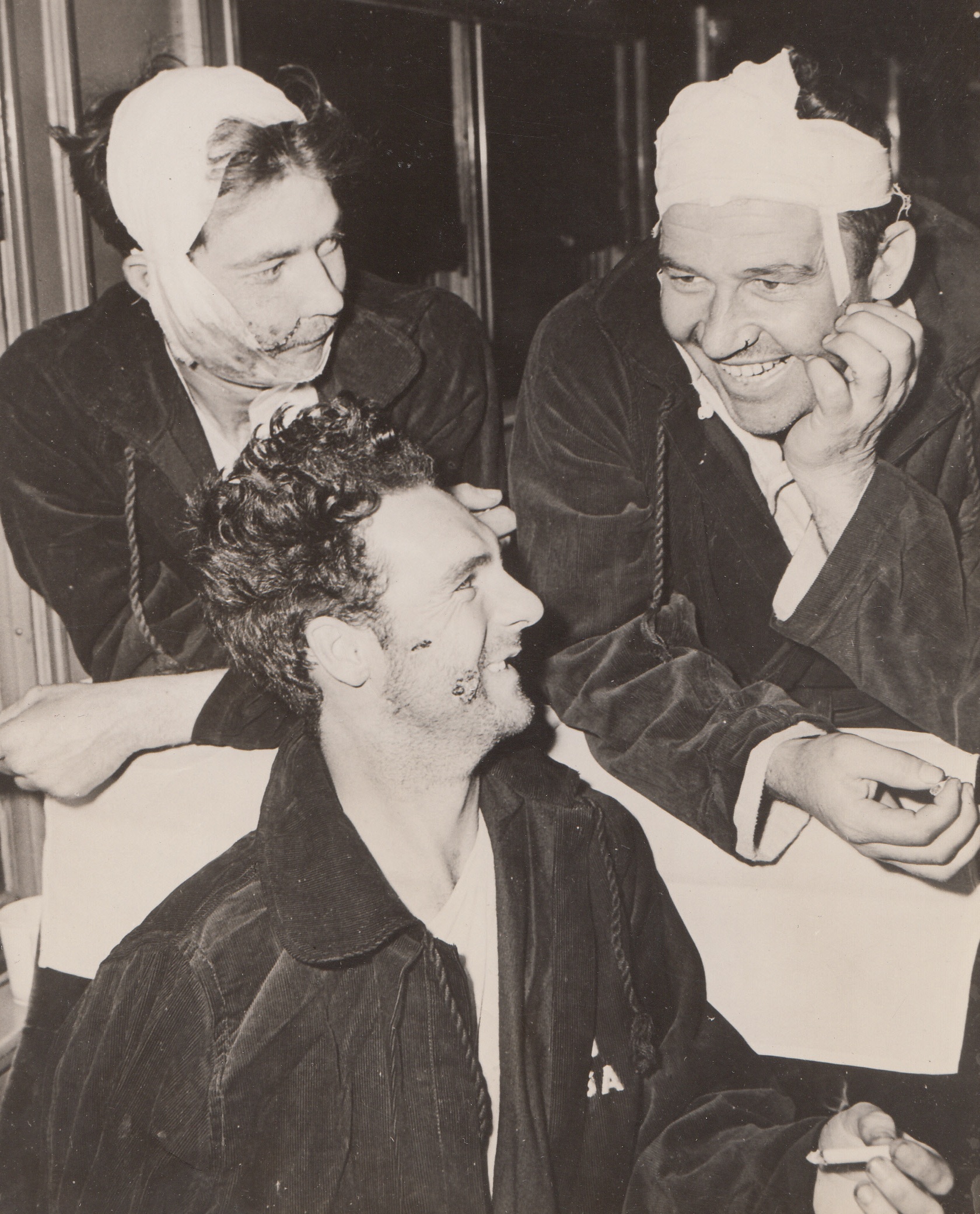 Three Attu Musketeers, 6/6/1943. Seattle, Wash. – Aboard an Army hospital train, these three soldiers who are recovering from head wounds caused by bursting mortar shells, jokingly recall their experiences with the gorilla-like Jap troops on Attu Island, as they are being taken to a Pacific Northwest Army hospital to recover. They are Sgt. J.R. Allison (left rear), Merced, Calif.; Sgt. Lawrence Bradley, Alta Vista, Kan.; and Sgt. Enest Pearce (front) of Murray, Utah. 6/6/43;