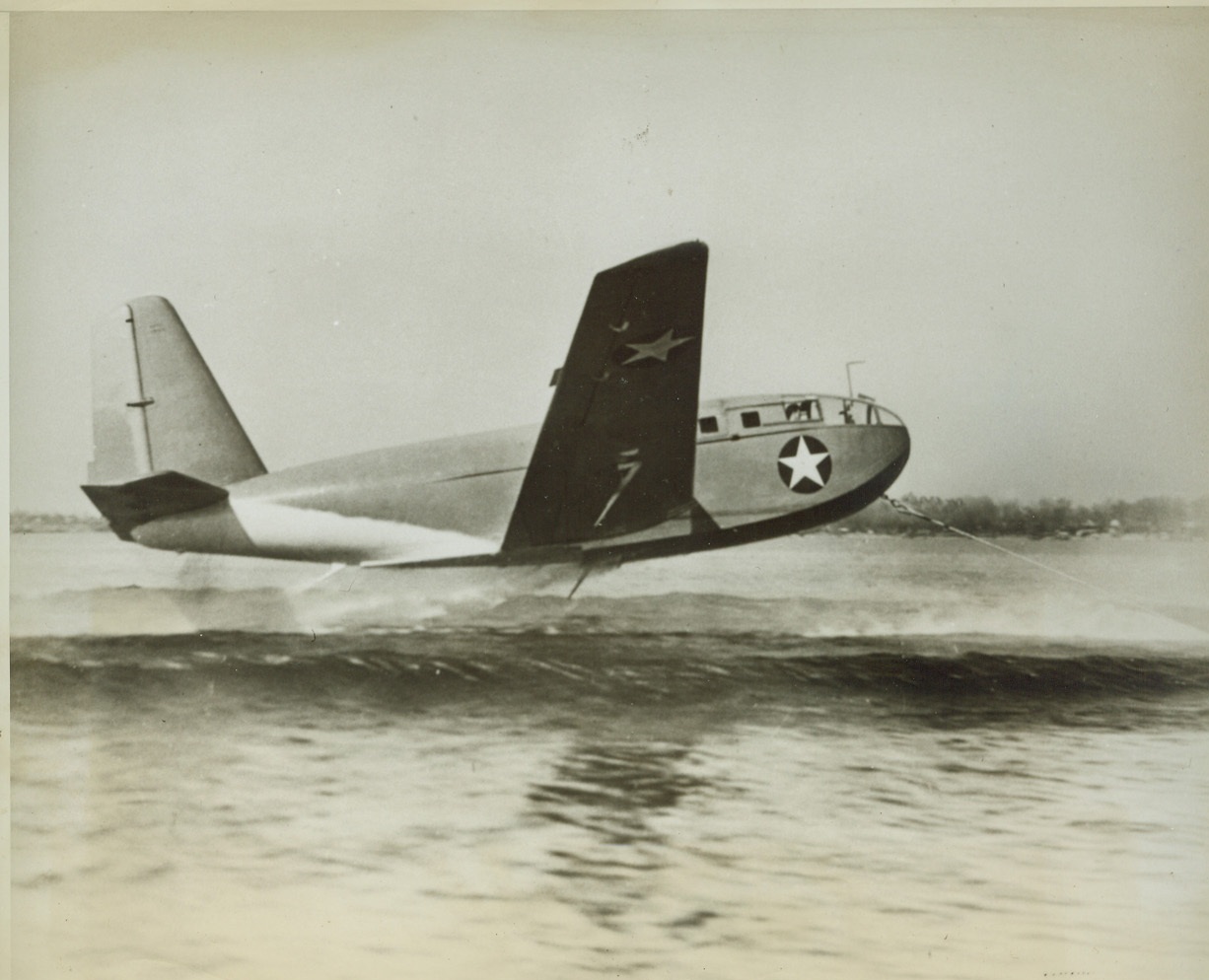 Glider Takes to Water, 6/14/1943. An amphibious transport glider skims the water in the first picture released of one of America’s newest invasion weapons to be used by the Marines. Produced of moulded plywood and other non-strategic materials, the sky fish that can swim was designed for the U.S. Navy by the Allied Aviation Corp., of Baltimore, MD.  Credit: ACME.;