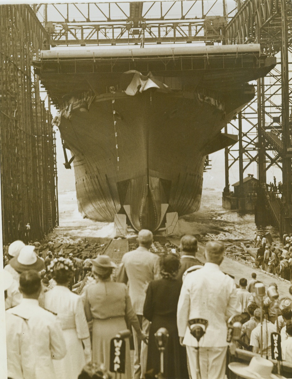 NEW CARRIER HORNET LAUNCHED, 8/31/1943.NEWPORT NEWS, VA.- The new 25,000 ton flattop Hornet slides down the ways at Newport News, christened by Mrs. Frank Knox, wife of the U.S. Secretary of the Navy. Knox paid tribute to Doolittle’s men who last year took off from the former Hornet to raid Tokyo, and said Japan could expect bigger and better raids in the future. Credit: OWI Radiophoto from ACME;